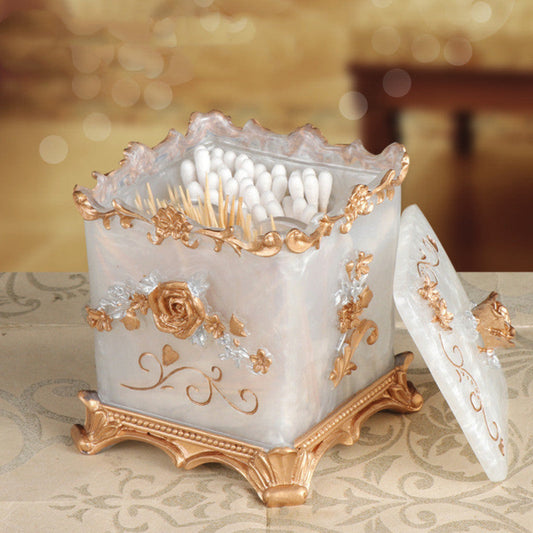 Decorative candle holder with intricate gold designs on a patterned surface.
