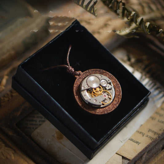 Steampunk-style pendant with mechanical design on a black box