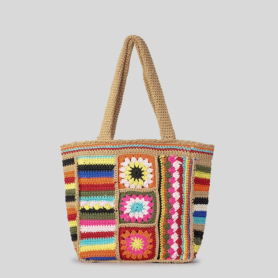 Colorful crochet bag with patterned squares on a gray background