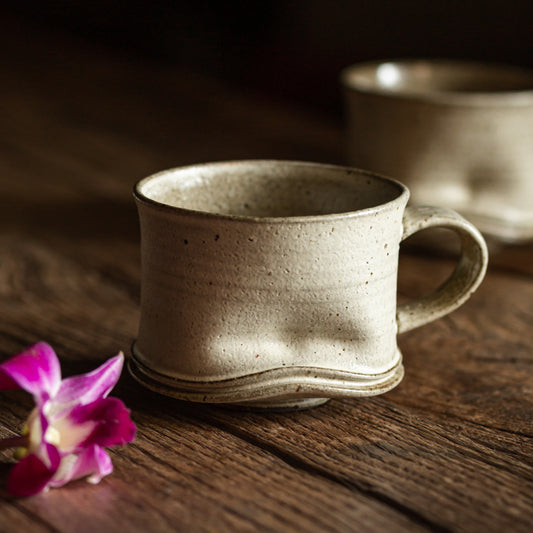 Ceramic mug on a wooden surface with a blurred background