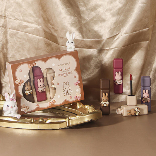 Makeup set with bunny-themed packaging and accessories on a beige background