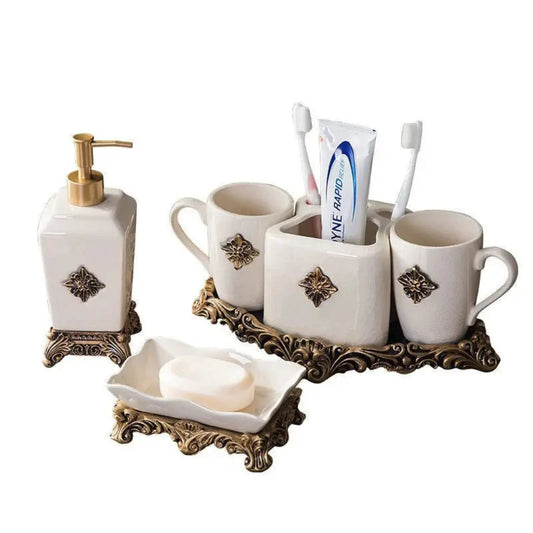 Bathroom accessory set with white cups, soap dish, and dispenser on a white background