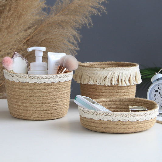 Three woven baskets with lace trim containing various items on a white surface.