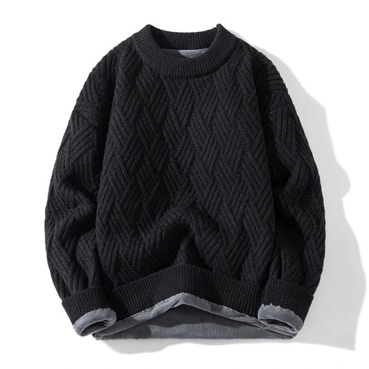 Black cable knit sweater on a white background