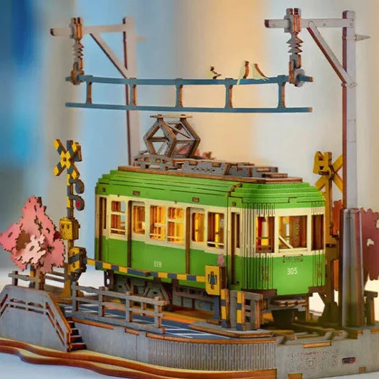 Model of a green tram with wooden elements on a blurred background