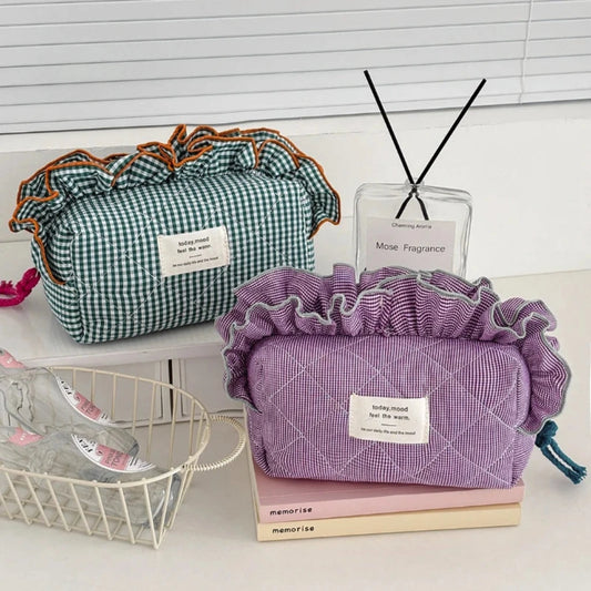 Two fabric bags, one green and one purple, on a surface with a diffuser and basket in the background.