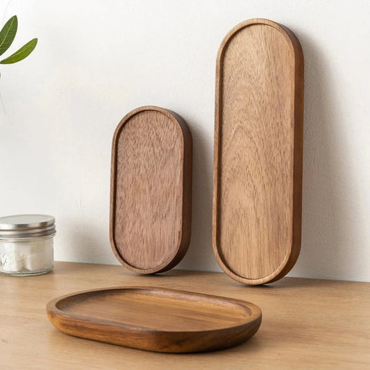Three wooden trays of different sizes on a light wooden surface with a white background.