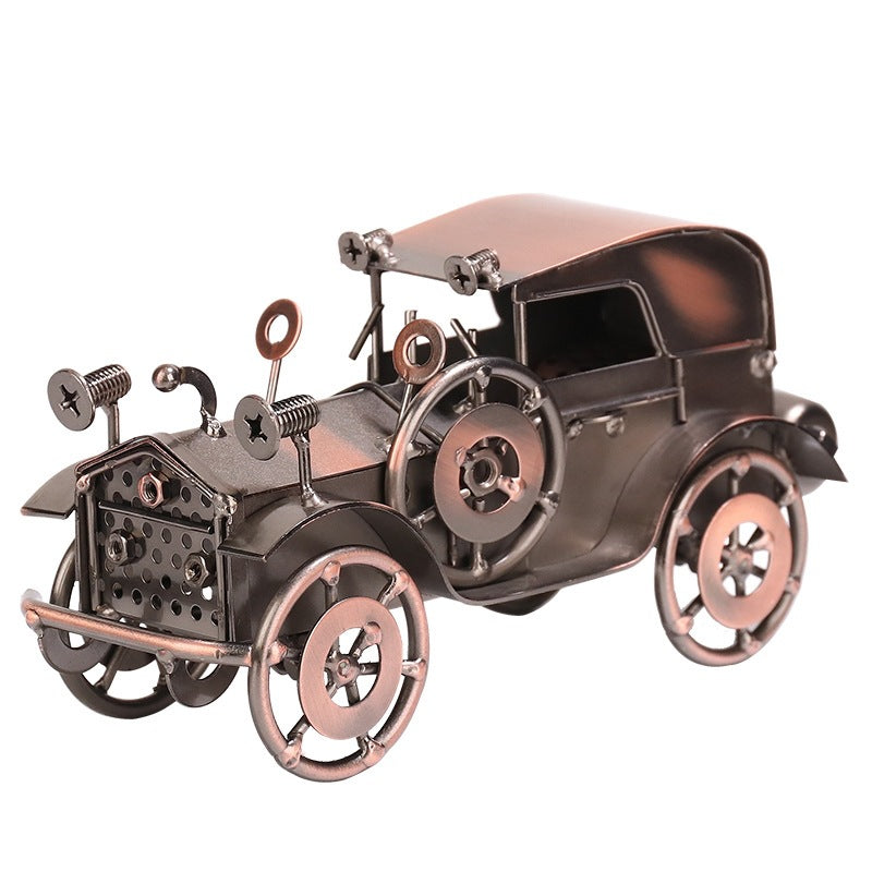 Metallic model of an old-fashioned car on a white background