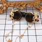 Sunglasses with decorative chain and gold monkey designs on a checkered background