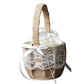 Flower girl basket with lace detailing and a white ribbon on a white background