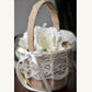 Decorative basket with lace detailing and white flowers on a neutral background