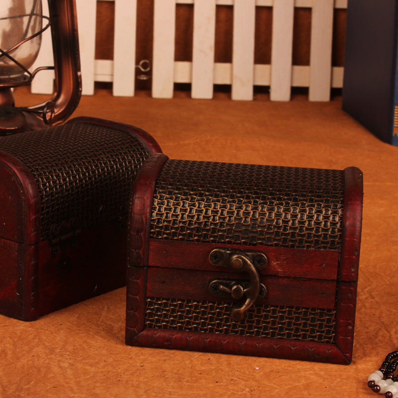 Wooden treasure chest with woven top on a textured surface
