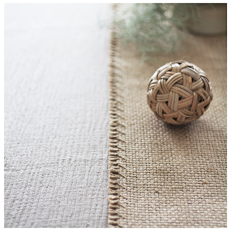 Woven decorative ball on a textured surface with a blurred background