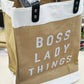 Brown tote bag with 'BOSS LADY THINGS' text on a white background