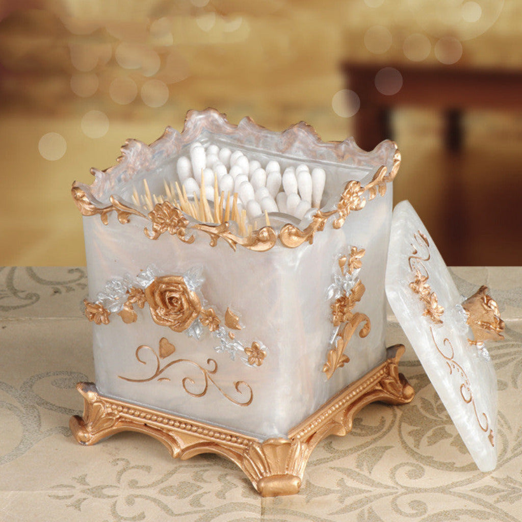 Decorative candle holder with intricate gold designs on a patterned surface.