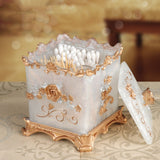 Decorative candle holder with intricate gold designs on a patterned surface.