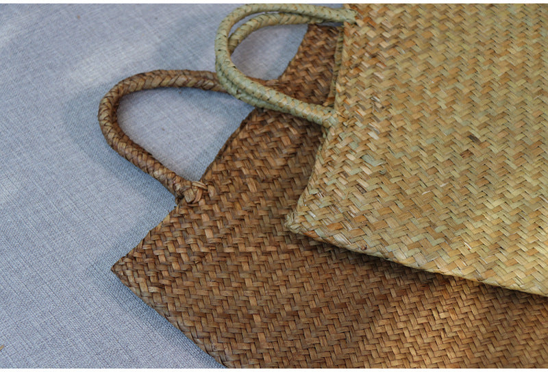 Close-up of a woven straw bag on a textured surface
