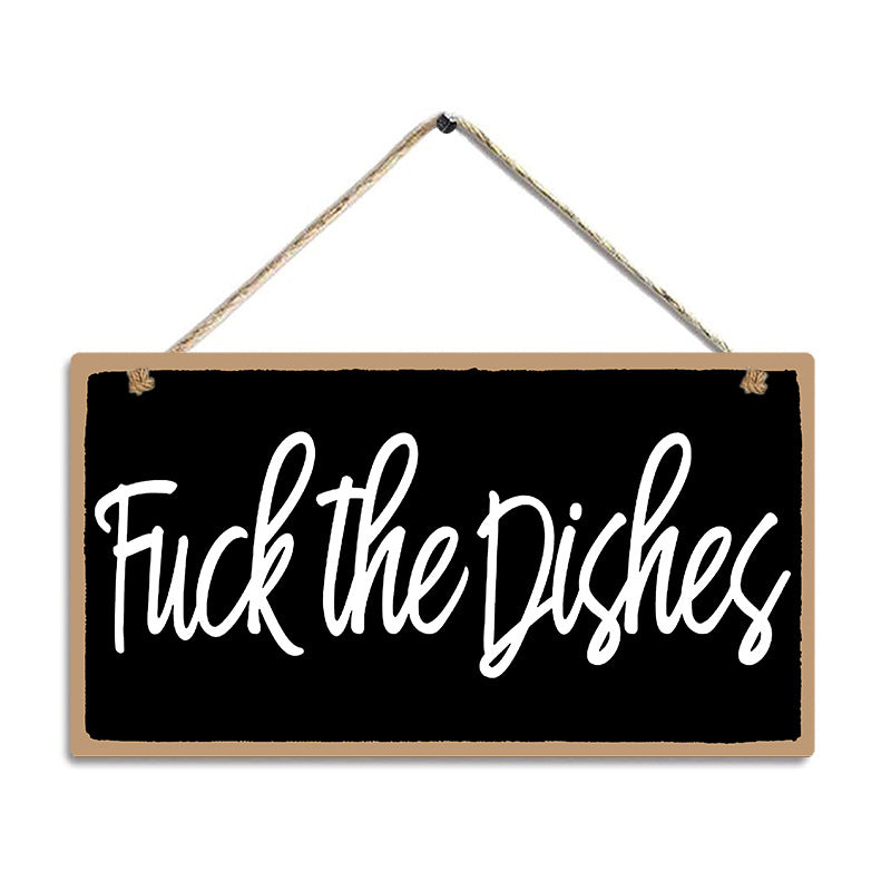 Hanging sign with text 'Fuck the Dishes' on a black background