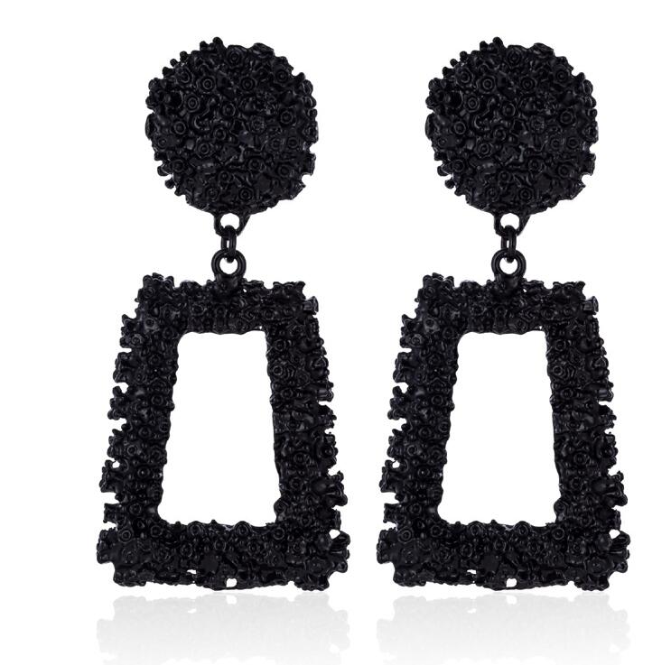 Black textured earrings with square drops on a white background
