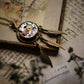 Vintage-style necklace with mechanical design on an old book page