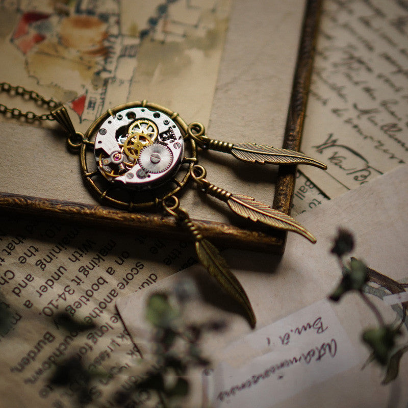 Vintage-style necklace with mechanical design on an old book page