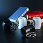 Four mugs with knuckle-duster handles on a dark surface with books in the background