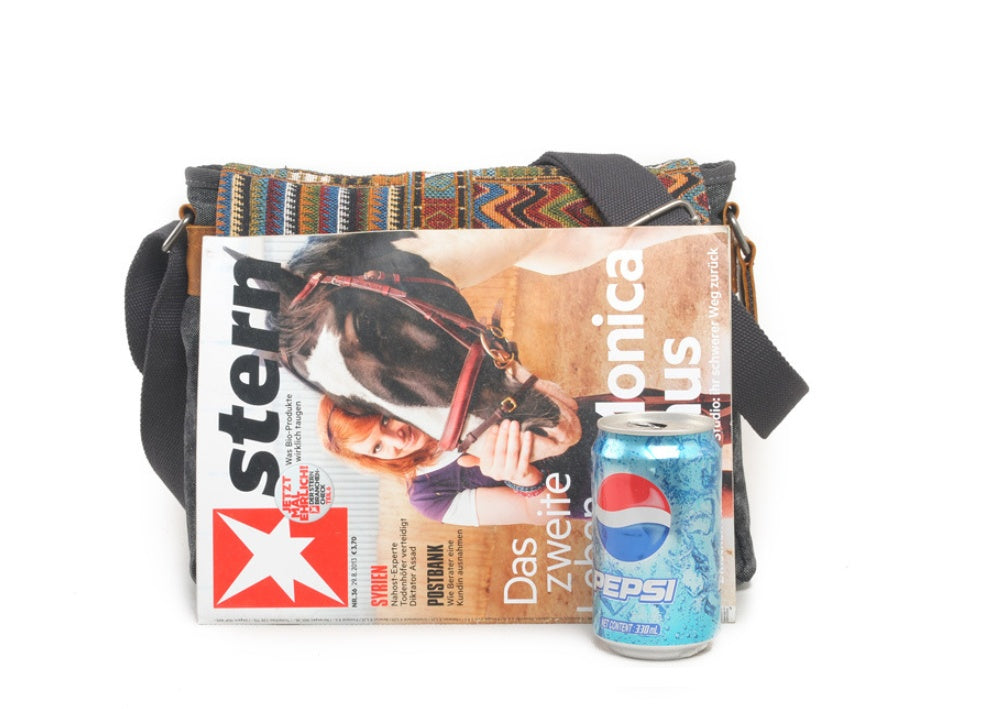 Multicolored bag with a magazine and a can of Pepsi on a white background