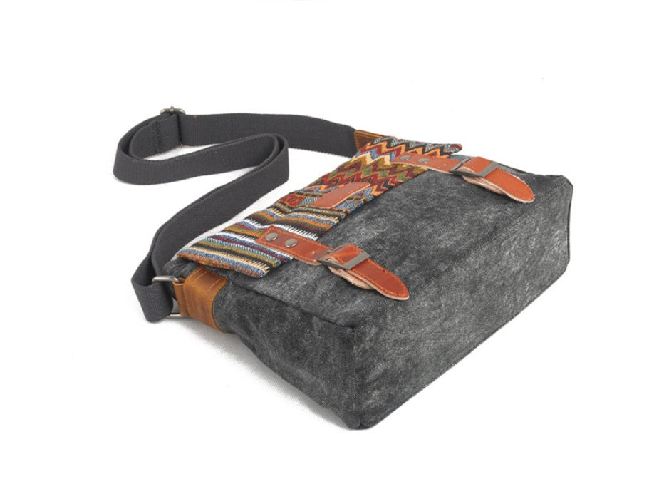 Gray bag with patterned strap on a white background