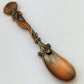 Decorative copper spoon on a white background