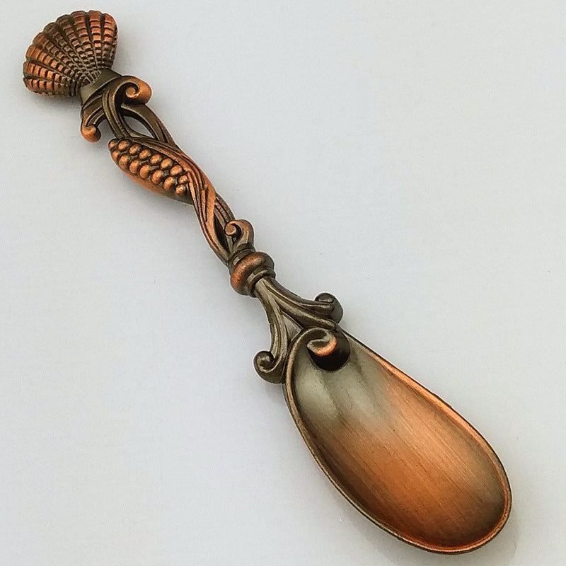 Decorative copper spoon on a white background
