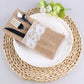 Placemat with lace napkin, cutlery, and white plate on woven placemat