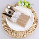 Placemat with lace napkin, cutlery, and white plate on woven placemat