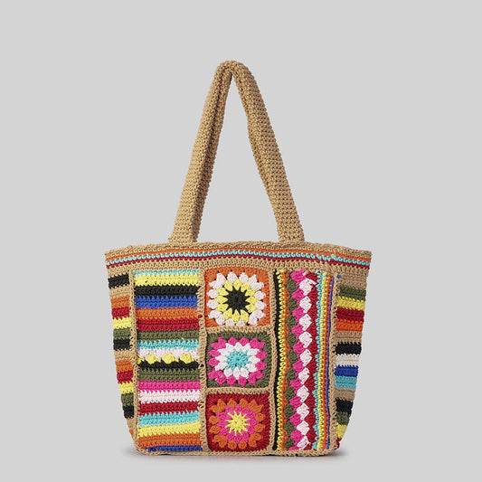 Colorful crochet bag with patterned squares on a gray background