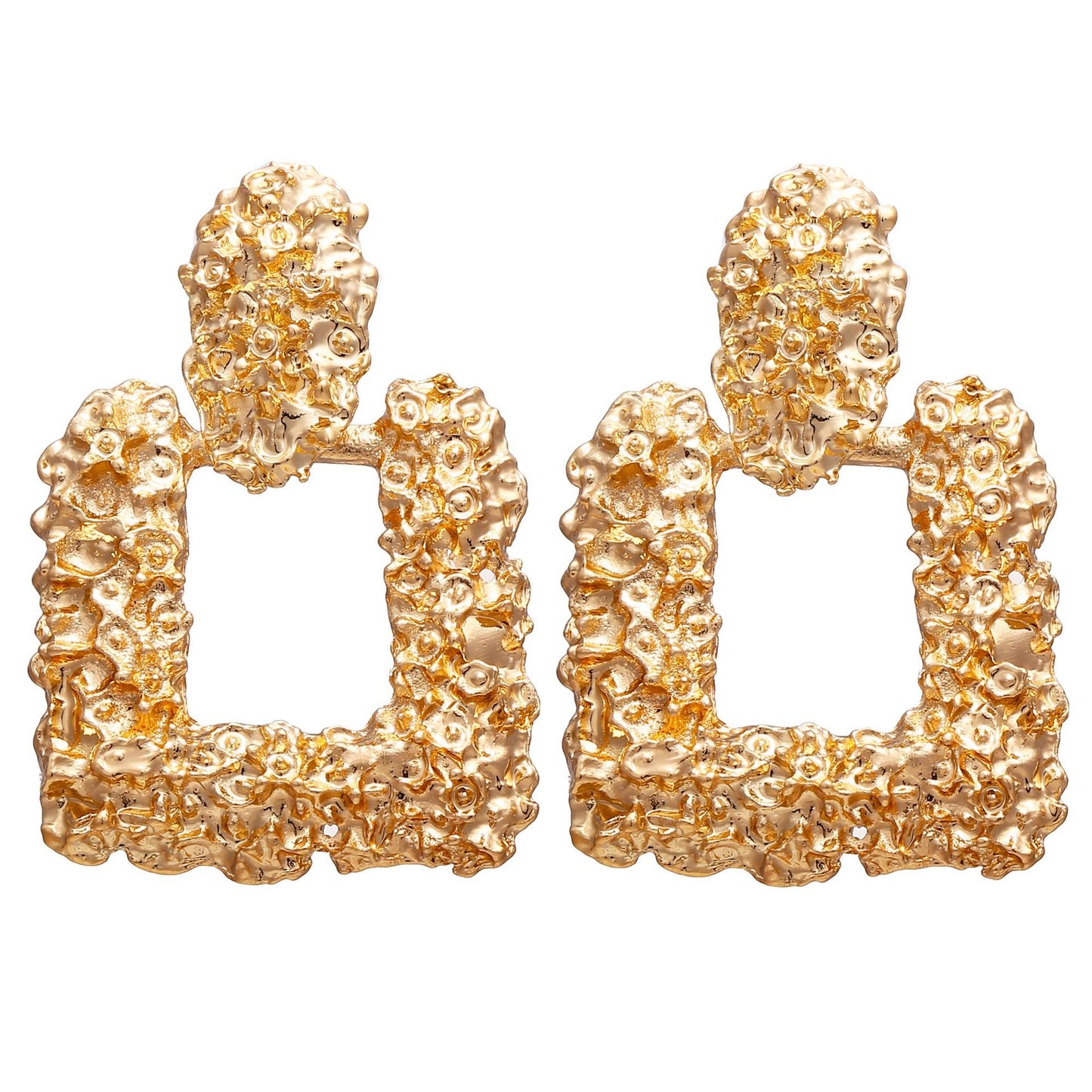 Gold textured earrings on a white background
