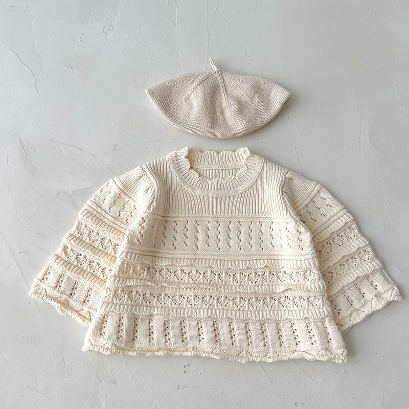 Knitted baby sweater and hat set on a light gray background