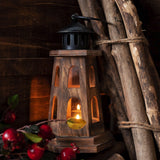 Wooden lantern with a candle inside, surrounded by natural elements like branches and berries.