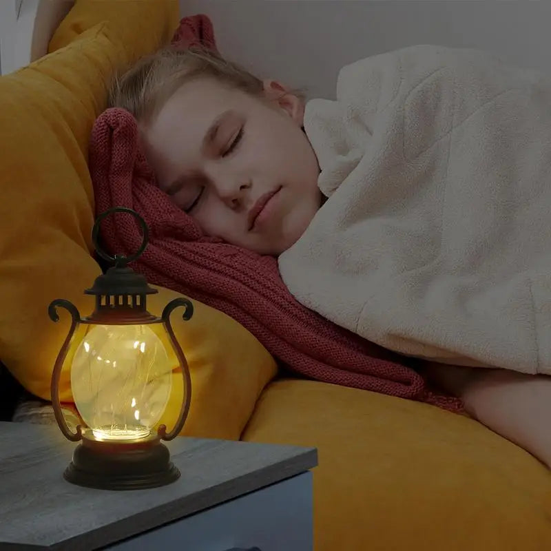 Person sleeping on a yellow pillow with a glowing lantern next to them