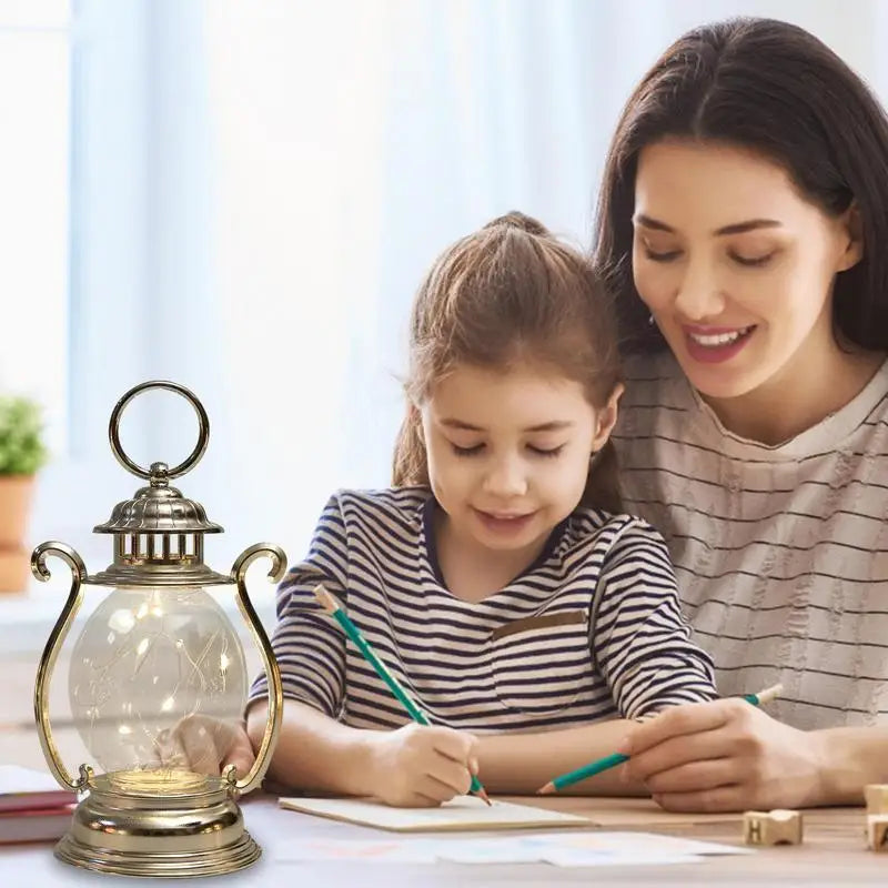 Woman and child sitting together with a lantern on a table