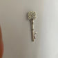 Decorative silver key on a plain background