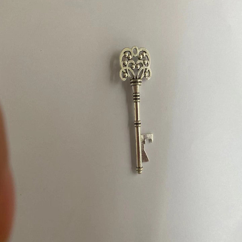 Decorative silver key on a plain background