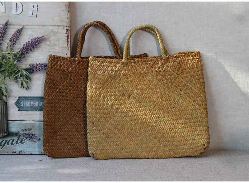 Two woven bags, one brown and one gold, on a light surface with a neutral background.
