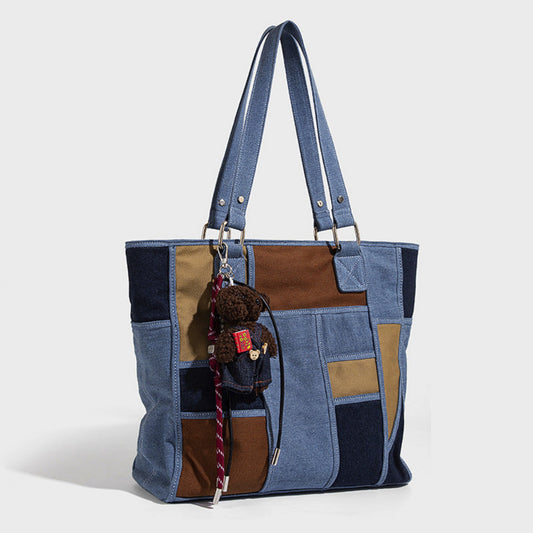 Patchwork tote bag with a teddy bear keychain on a white background