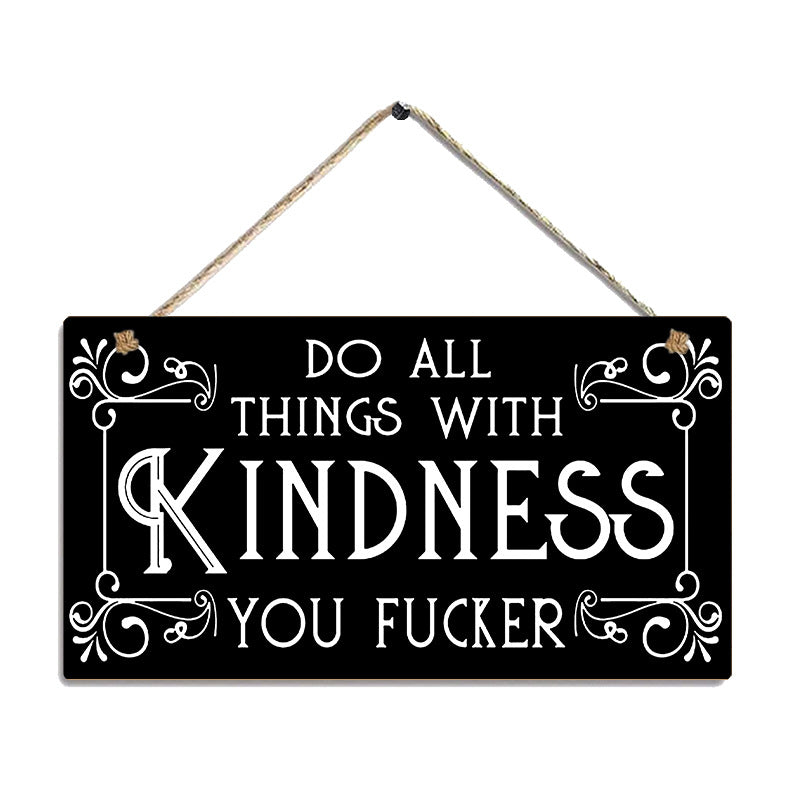 Black sign with white text 'Do all things with kindness you fucker' on a white background