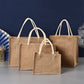 Three brown jute bags of different sizes on a gray surface with a blue background