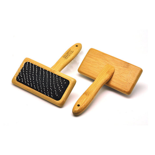 Two wooden grooming tools with black bristles on a white background