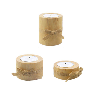 Three bamboo candle holders with burlap ribbons on a white background