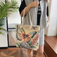 Person holding a tote bag with butterfly design indoors