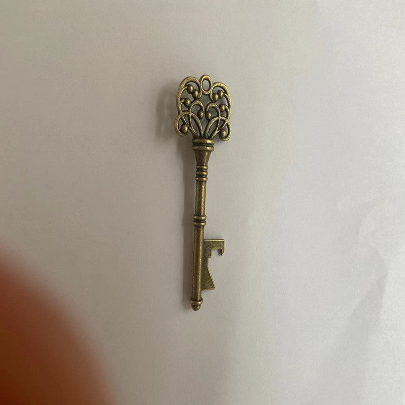 Decorative brass key on a white background