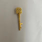 Decorative gold key on a light gray background
