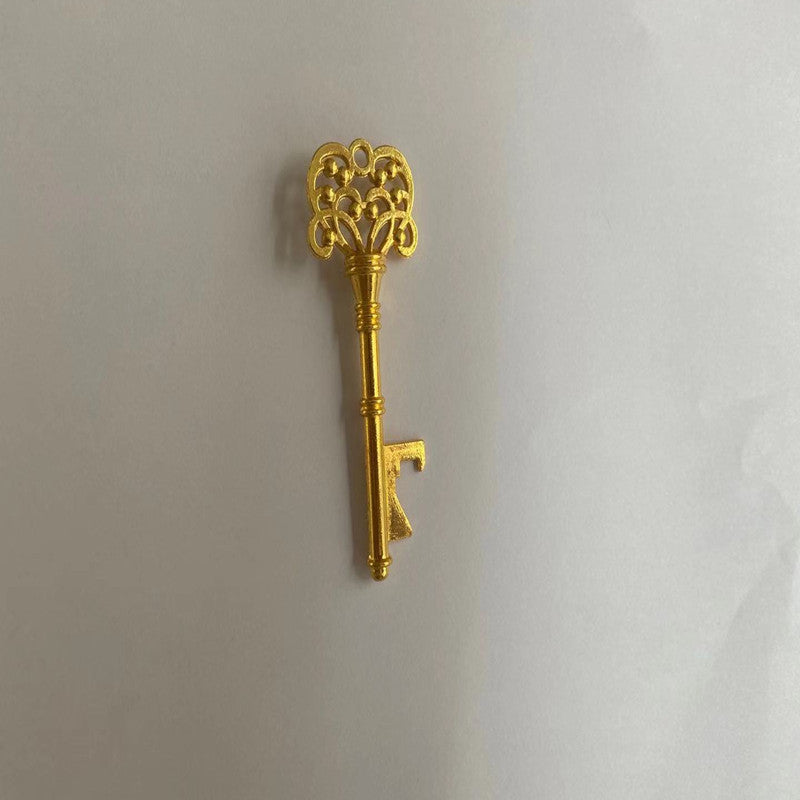 Decorative gold key on a light gray background